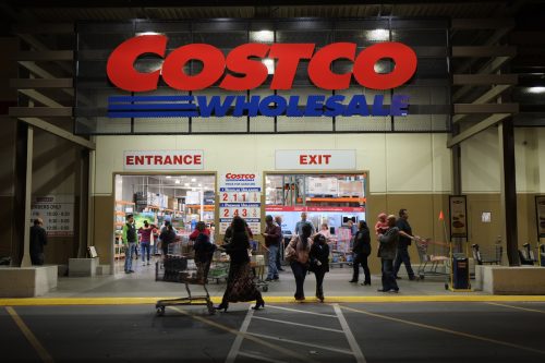 Rancho Cordova, California, USA - December 1, 2016: Late evening shot of people walking in and out of a Costco Wholesale warehouse in Rancho Cordova. Costco Wholesale operates an international chain of membership warehouses, carrying brand name merchandise at substantially lower prices.