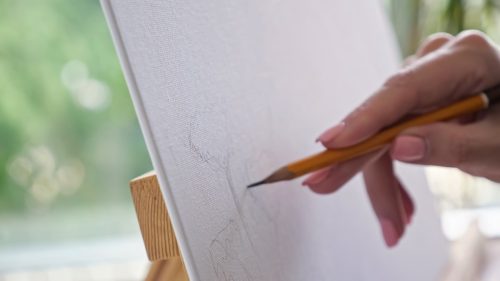 close up of someone drawing on a canvas
