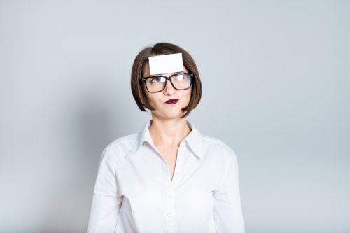 portrait of a business woman with a blank sticker on forehead