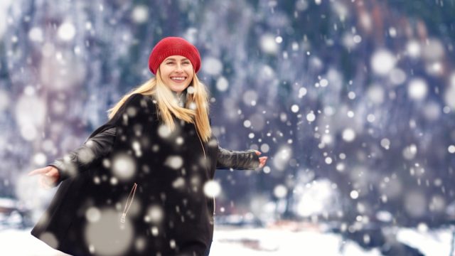 woman in red hat enjoying snow