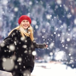 woman in red hat enjoying snow