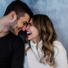 man smiling as his girlfriend expresses love messages for him