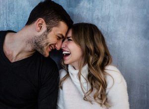 man smiling as his girlfriend expresses love messages for him