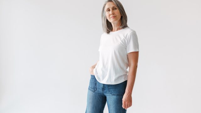 Mature woman gray hair white tshirt jeans
