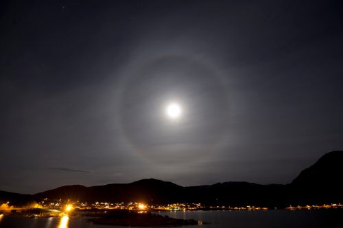 A halo around the moon over the city of TromsA in arctic Norway.