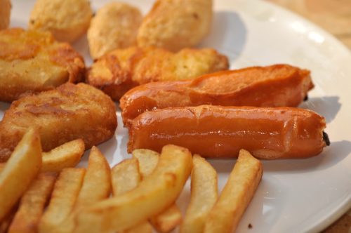 French fries, hot dog nuggets on a white plate