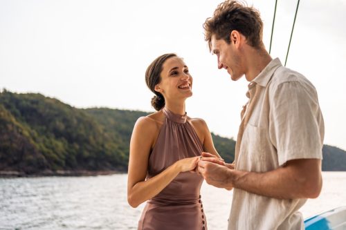 young man asking a woman romantic questions to ask your girlfriend while on a boat