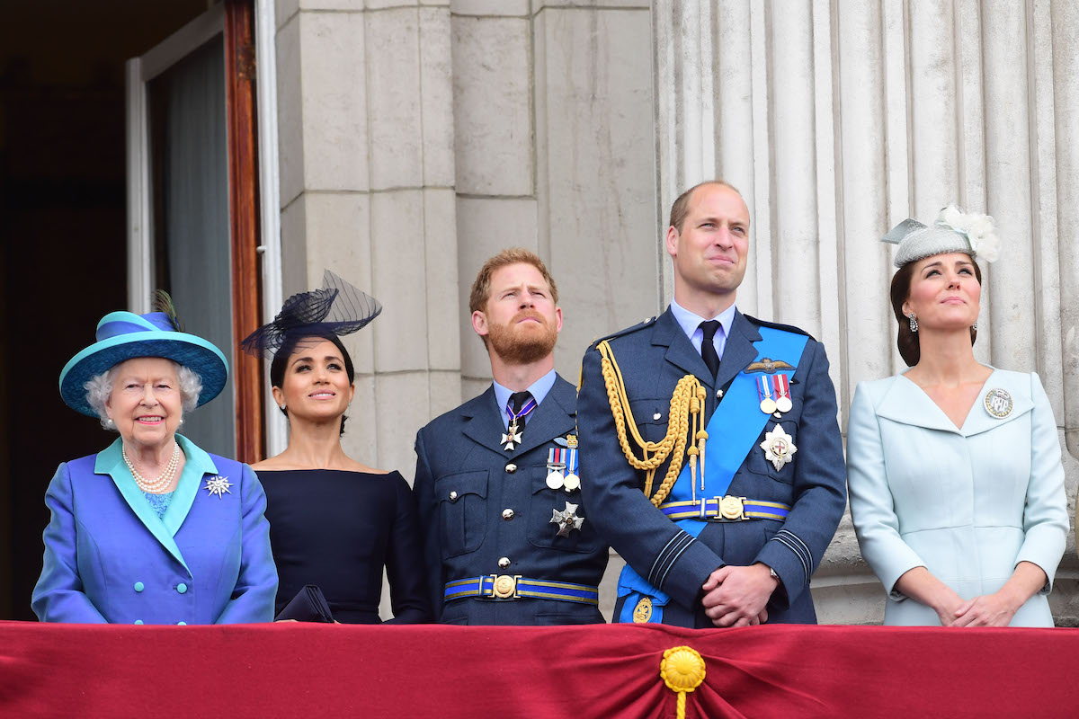 Queen Elizabeth II, Meghan Duchess of Sussex, Prince Harry Duke of Sussex, Prince William Duke of Cambridge and Katherine Duchess of Cambridge watch the RAF 100th anniversary flypast at Buckingham Palace in 2018