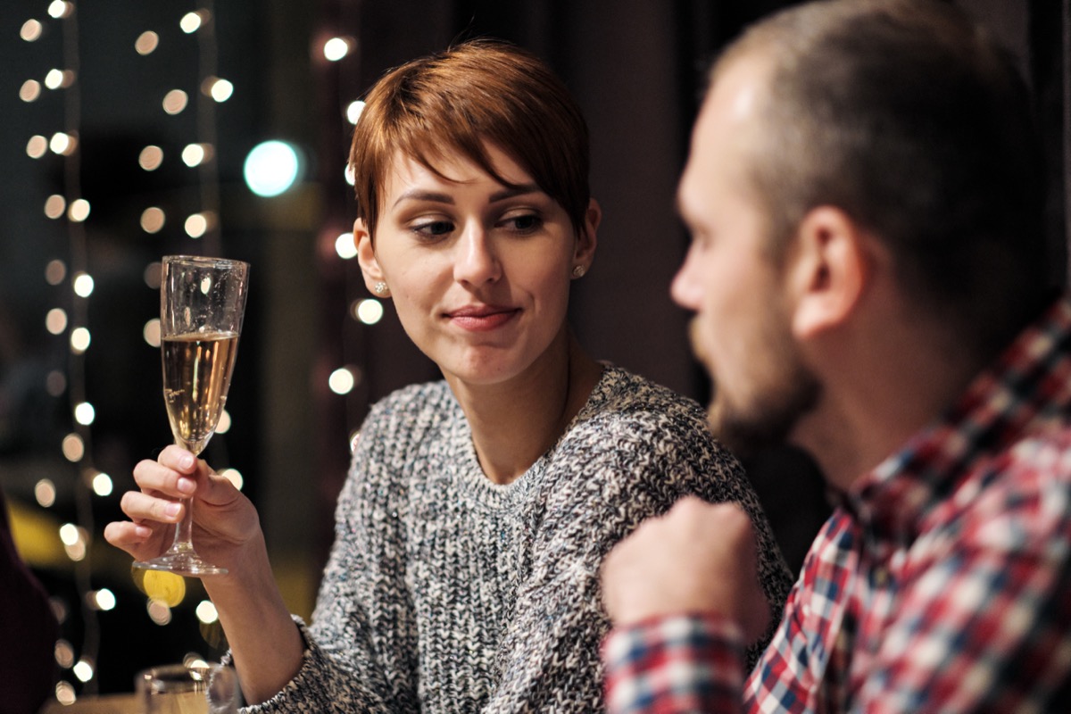 man and woman at holiday dinner party