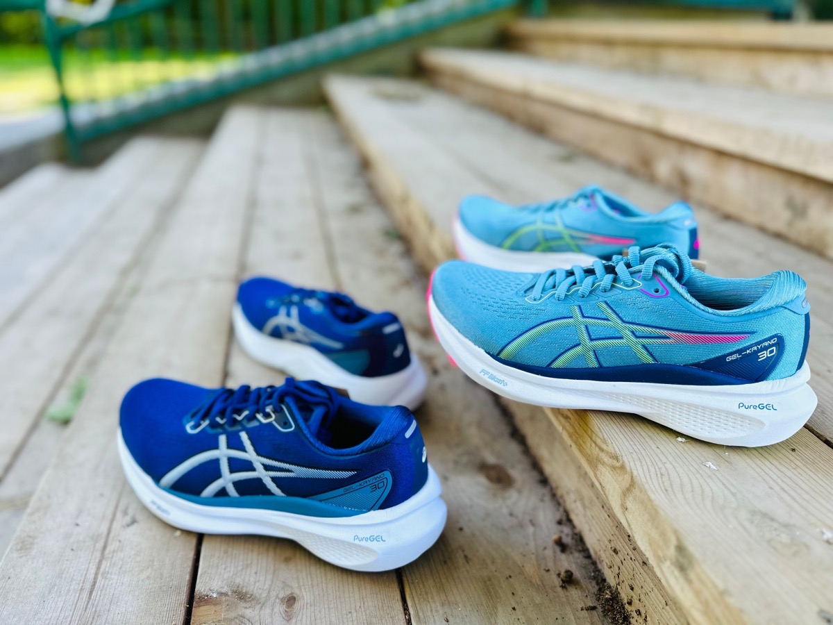two blue pairs of asics kayano sneakers on outdoor steps