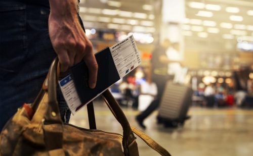 traveler with id and boarding pass at the airport
