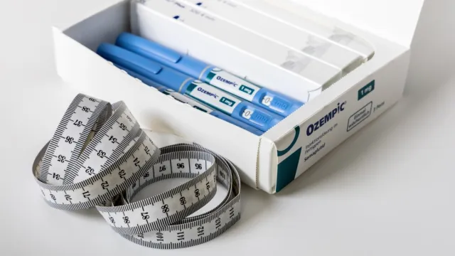 ozempic injections in box with measuring tape