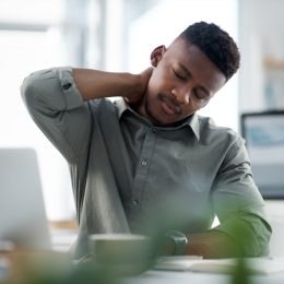 Shot of a young businessman working on a computer in an office
