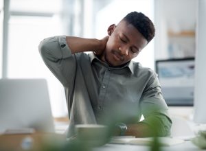 Shot of a young businessman working on a computer in an office
