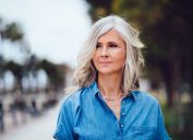 Beautiful fashionable mature woman with gray hair outdoors in the city