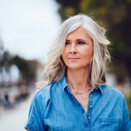 Beautiful fashionable mature woman with gray hair outdoors in the city