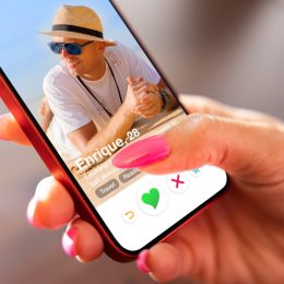woman swiping through the Tinder app on her phone
