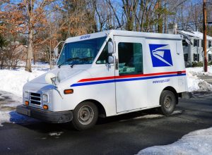 PRINCETON, NJ -10 FEB 2021- Winter view of a delivery truck from the United States Postal Service (USPS) on the street in New Jersey, United States after a snowfall.