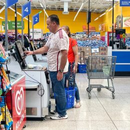 customers using self-checkout at walmart