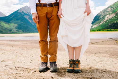 Groom and bride in hiking shoes.