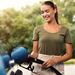 woman smiling while filling gas