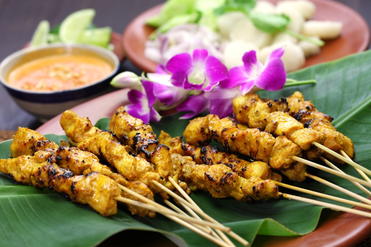 Chicken Satay displayed on large leaf