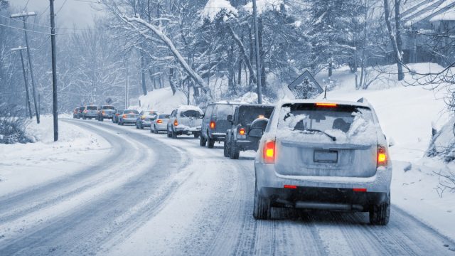 Line of Cars Driving in Snow