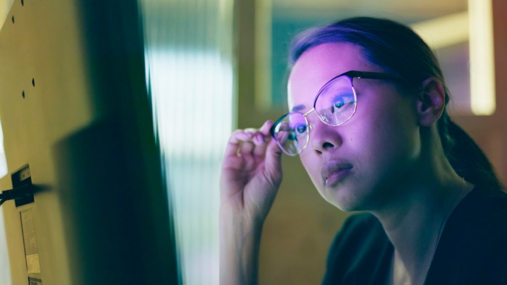 Woman wearing glasses looking at computer screen