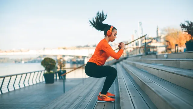 Fitness woman jumping outdoor in urban environment