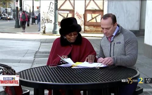 Lois White and WSB-TV Channel 2 anchor sitting at outdoor table and looking at paperwork