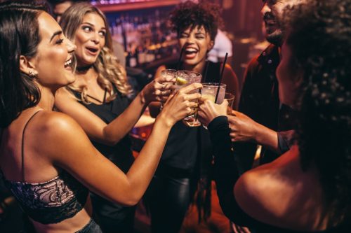 group of women toasting to one another during a night out