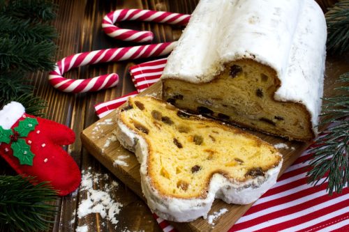 Traditional stollen and Christmas composition on the wooden background