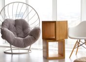 Modern minimalistic scandinavian style interior, wicker chair and wooden table, panoramic windows, selective focus
