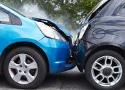 Close Up Of Two Cars Damaged In Road Traffic Accident