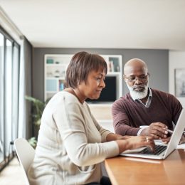 older couple looking at a computer together