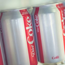 A close up of Diet Coke cans in a fridge