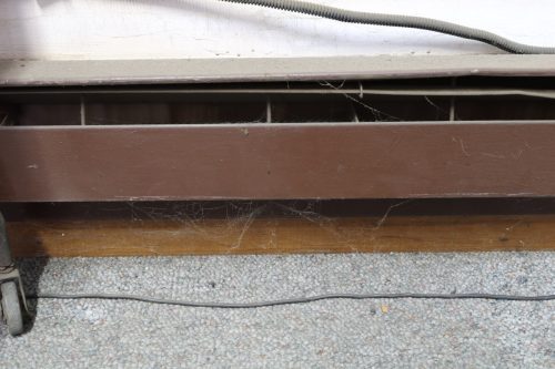 Extremely dirty electric baseboard heater in need of maintenance