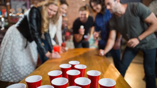 group of friends playing a drinking game