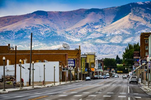 the main street in western town of Ely, Nevada is seen against backdrop of mountain range