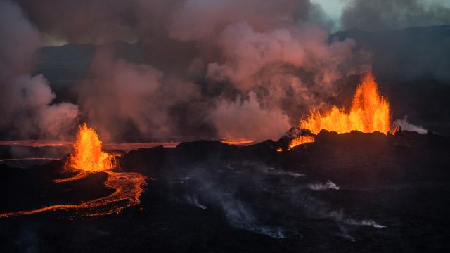 An aerial shot of a fissure volcanic eruption in Iceland with lava floes