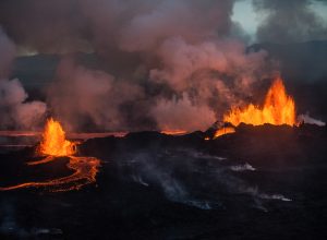 An aerial shot of a fissure volcanic eruption in Iceland with lava floes