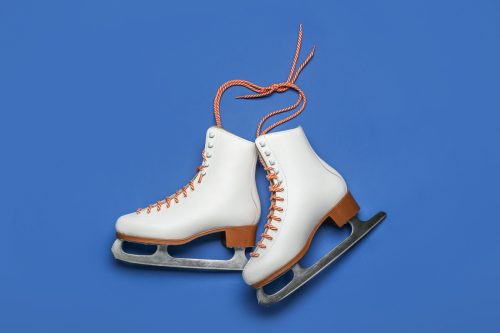 pair of ice skates over blue background