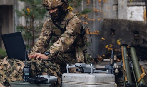 soldier engineer transmits aerial pictures and data from drone to artillery.