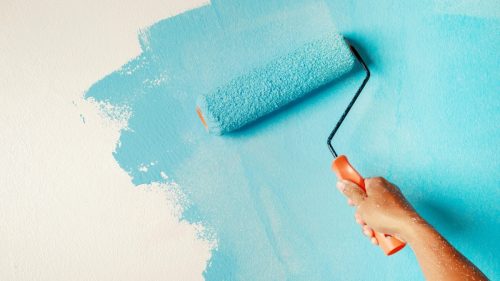 painting interior wall with paint roller