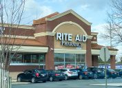 A Rite Aid storefront with cars in the parking lot