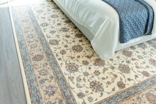 Traditional woven rug in beautiful blue tone bedroom.