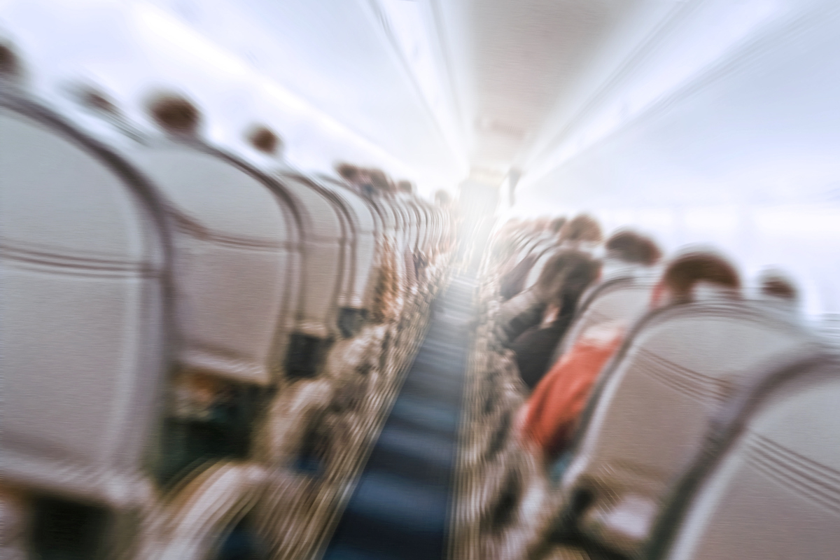 Blurry image of an airplane interior tilted, to show the concept of turbulence.