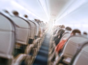 Blurry image of an airplane interior tilted, to show the concept of turbulence.