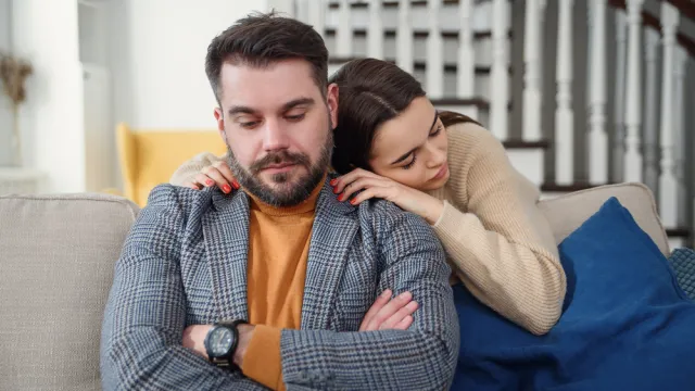 Clingy woman apologizing to boyfriend or husband
