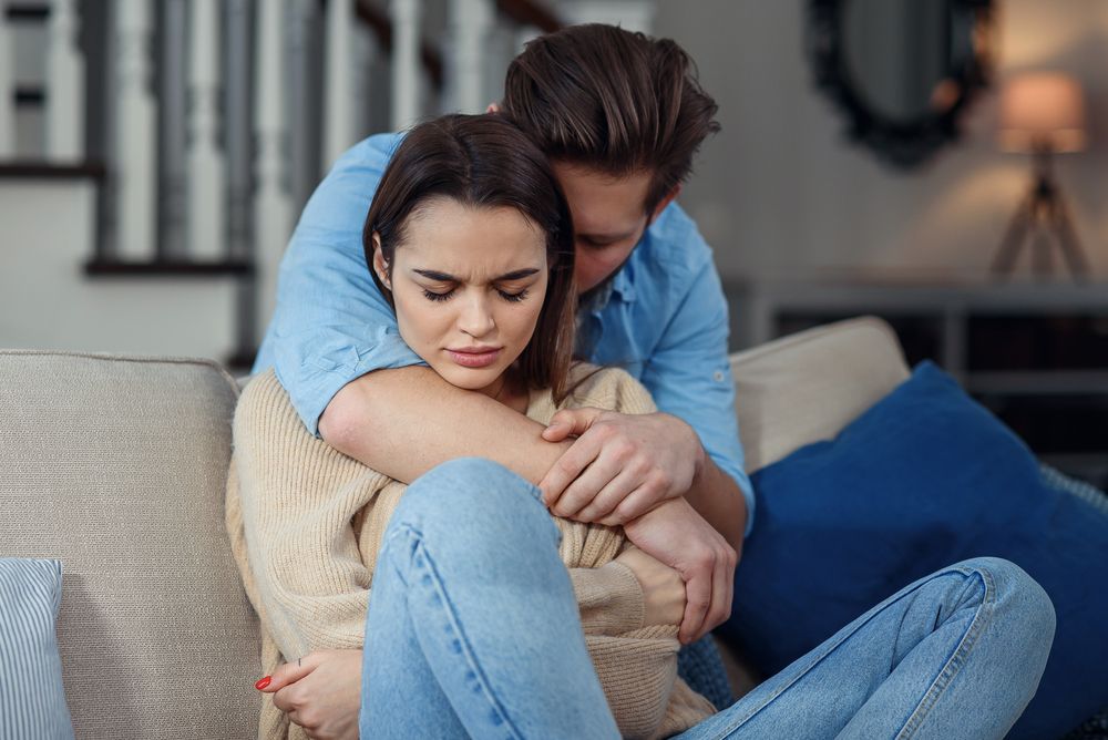 Young couple with man apologizing after fight or cheating.